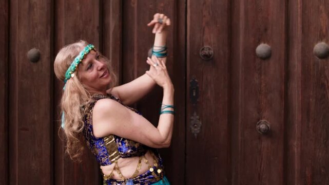 Senior woman performing belly dance warm ups background