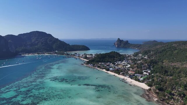 Cinematic drone view of Phi Phi island with tropical coastline and crystal water perfect for travel inspiration destination marketing and holiday visuals