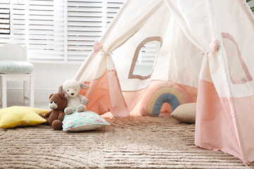 Toy wigwam with pillows in room, closeup © New Africa