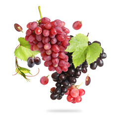 Fototapeta premium Fresh juicy grapes and green leaves falling against white background