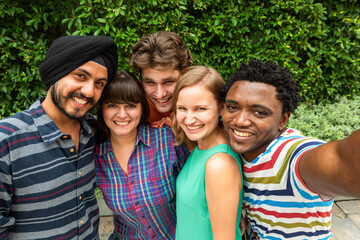 Obraz premium Diverse friends smiling outdoors.