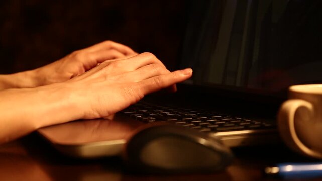 Business woman typing on keyboard the fingers, drinking coffee. Laptop placed on the wooden desk near coffee cup and computer wireless mouse. Closeup series of videos from different angles