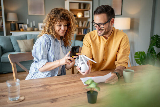 Couple setting up smart home security surveillance camera