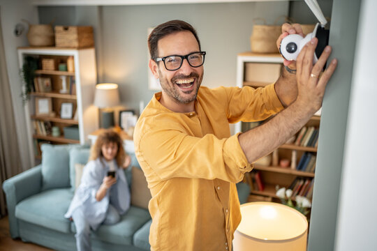 Man installing smart home security camera for safety