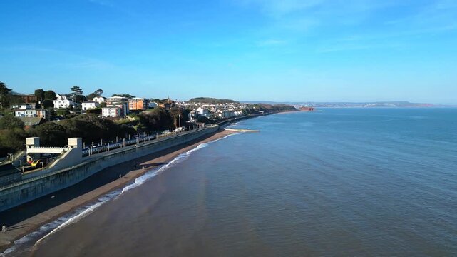 Dawlish, Devon, England: DRONE VIEW: An intercity train passes through Dawlish railway station on the seafront. Dawlish is a popular UK tourist destination on the mainline railway to London Paddington