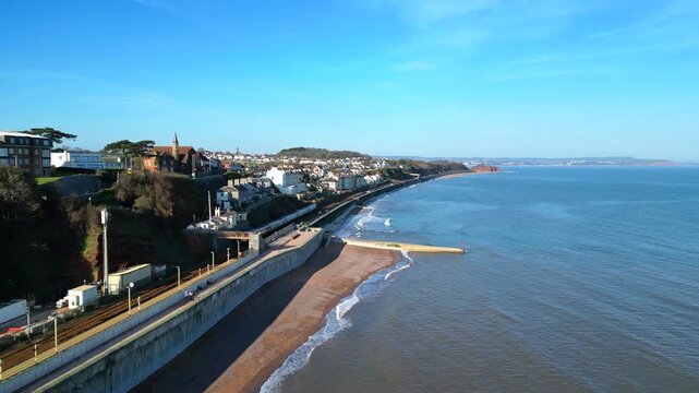 Dawlish, Devon, England: DRONE VIEW: An intercity train heads for Exeter along the Dawlish seafront. Dawlish is a popular UK tourist destination on the mainline railway to London Paddington. 