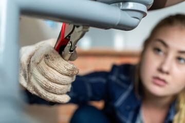 Focused plumber fixing pipe