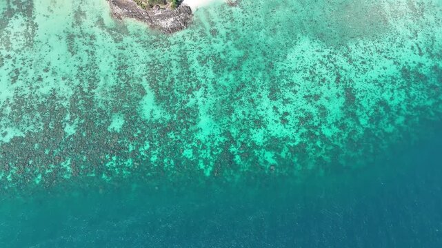 Drone footage capturing Phi Phi island coastline with clear ocean cliffs and sandy beach perfect for tourism promotion travel content and exotic destination visuals
