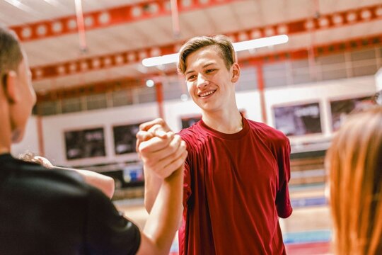 Teen athletes celebrating victory together