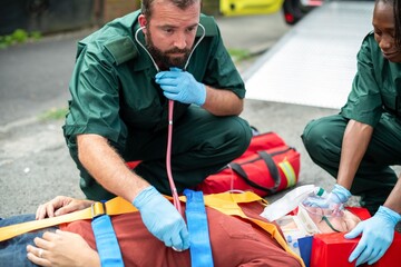 Emergency medical team assisting patient