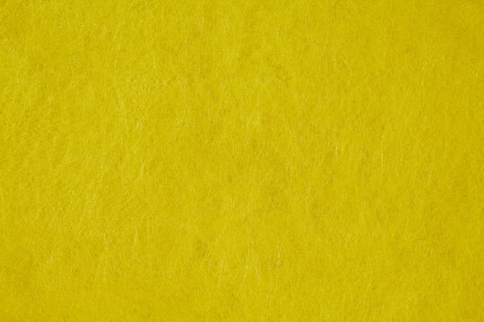 Vibrant yellow felt fabric texture background with soft fiber details