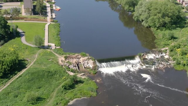 Aerial rotation over river and small waterfall