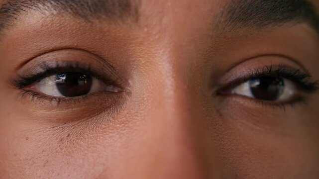 Close up African American woman dark eyes looking at camera vision outdoors in city cropped view female face with makeup healthy client eyesight sight ophthalmology laser correction medicine eye care