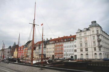 Nyhavn canal with historic sailing ships and colorful townhouses in Copenhagen © Tsyb Oleh