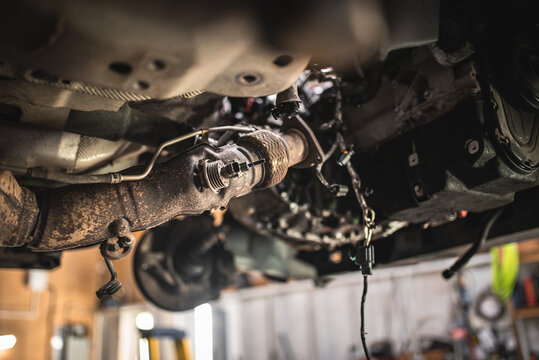 Close-up view of a car's exhaust system undergoing repair and maintenance