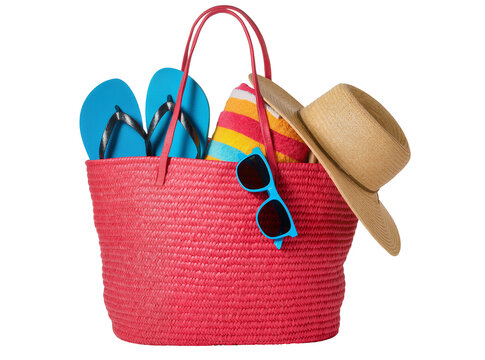 Isolated red wicker beach bag with summer vacation accessories like flip-flops and a hat.