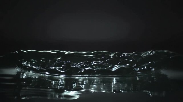 Forming shallow water after small impact, ejecting droplets and forming crest and ripples in studio
