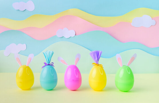 Spring Easter eggs with bunny ears on pastel background studio setup for holiday celebration