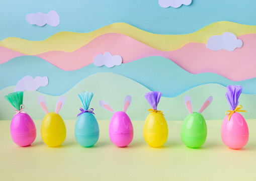 Colorful group easter eggs with bunny ears in studio during Happy Easter celebration pastel background