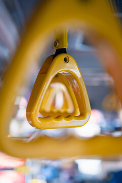 The handles on the bus are yellow