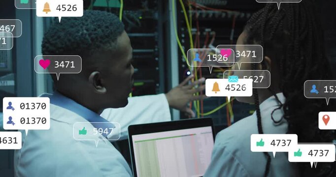 Laptop updating, two IT techs checking cables and patch panel while icons rising, diagnosing outage