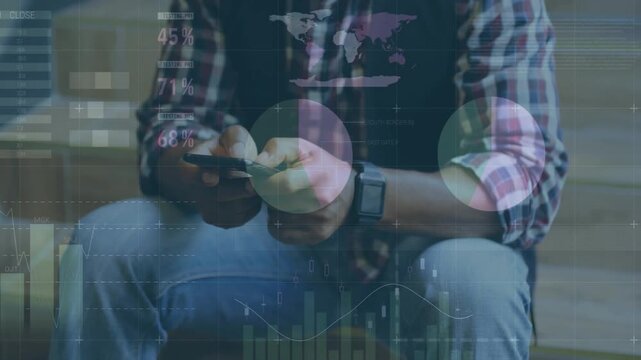 Tapping seated man in plaid shirt scrolling and reviewing smartphone data with charts at bench