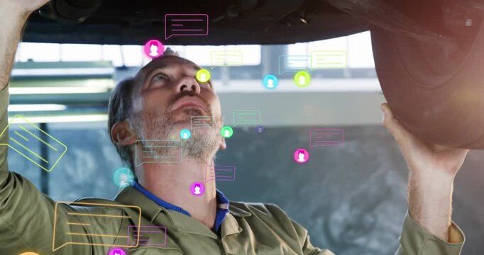Vertical video: Lifted vehicle causing tech inspecting underbody while icons clustering around part