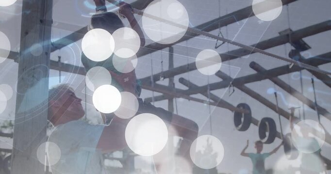 Child reaching bar, coach lifting steadying, bokeh overlay showing upward movement during training