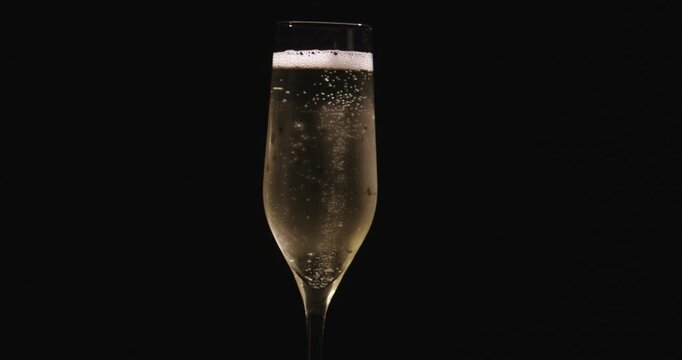 Champagne prosecco pouring into elegant glass. Champagne sparkling wine with bubbles. Champagne wine glass during pouring moment. Champagne bubbles dancing in glass.