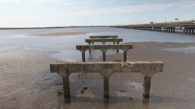 Looking out over the old pier supports and walking back to reveal the arch and surrounds.