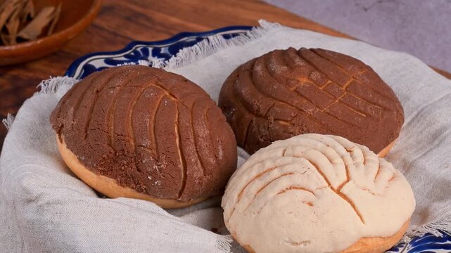 Assorted vanilla and chocolate Mexican conchas on a rotating table