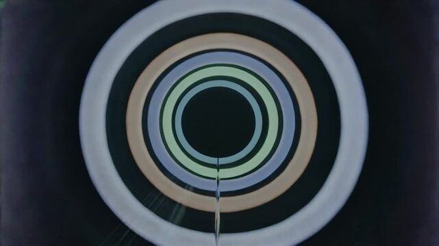 Color shift starting, concentric rings pulsing around core, showing rod, struts and metal object