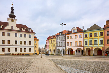 Fototapeta premium Historic town square with colorful buildings under cloudy sky