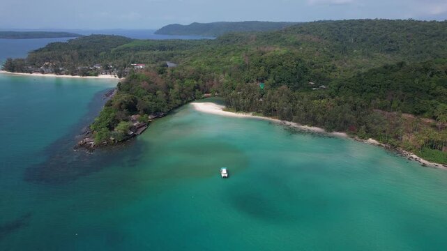 Boat On Shallow Turquoise Bay Near Yai Kee Beach In Koh Kood, Thailand. aerial pullback shot
