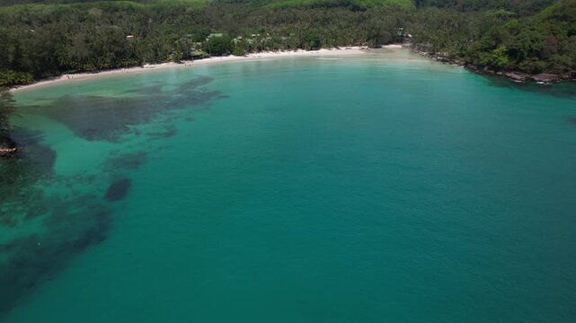 Aerial View Of Khlong Hin Beach In Koh Kood, Thailand, With Turquoise Waters And Dense Palm Forest.