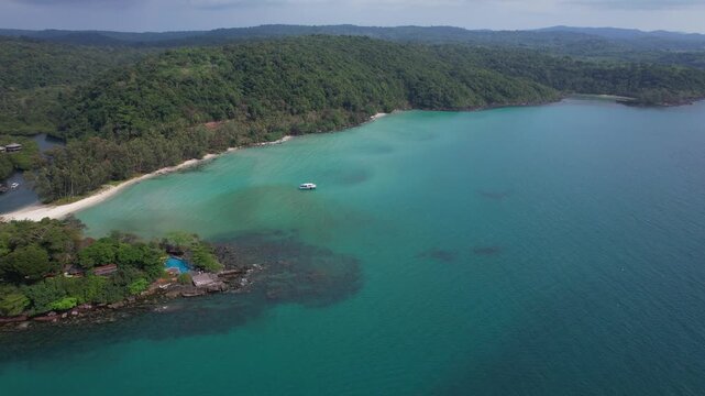 Boat Floating In The Turquoise Waters Near Yai Kee Beach - Captain Hook Resort In Koh Kood Island, Thailand. - aerial shot