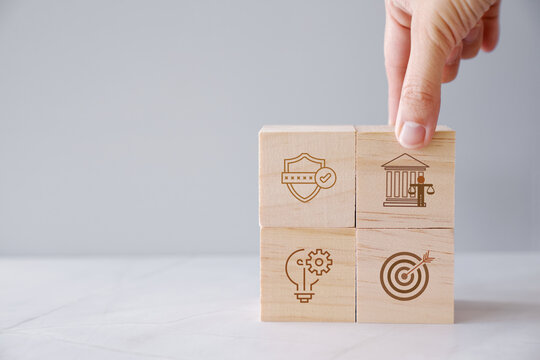government strategy administration policy governance leadership planning concept with businessman hand building a wooden block pyramid on office background for public sector development.
