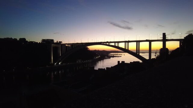 Arrabida bridge at sunset over douro river in porto, portugal