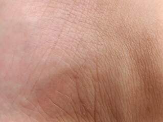Fototapeta premium Detailed macro view of human skin with natural wrinkles and fine lines.