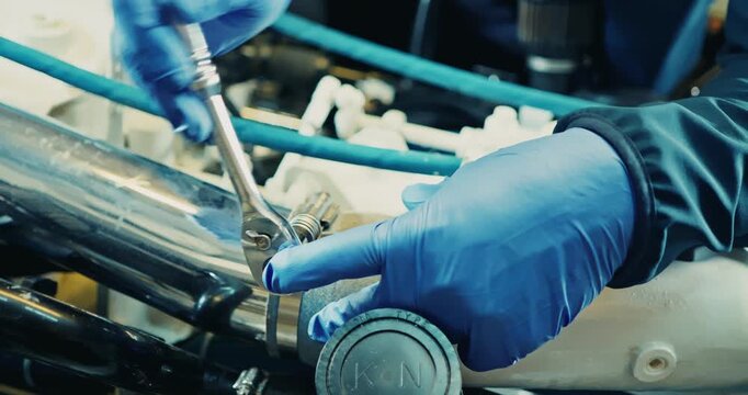 Mechanic Tightening Engine Bolts in Workshop