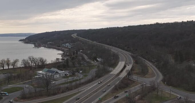 Ithaca, NY, USA - March 30, 2026  Late afternoon timelapse aerial video of the south end of Cayuga Lake and NYS Route 13 Ithaca, NY on an overcast spring day.