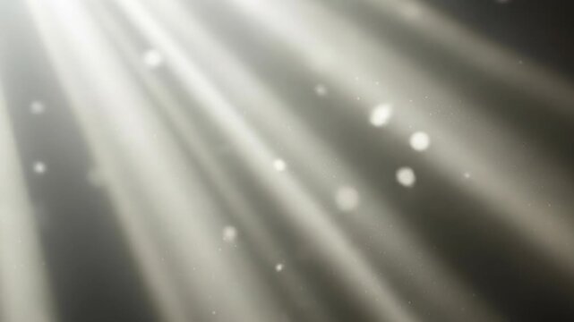 A gray background with bright white sunbeams and sparkles shining from the top left corner