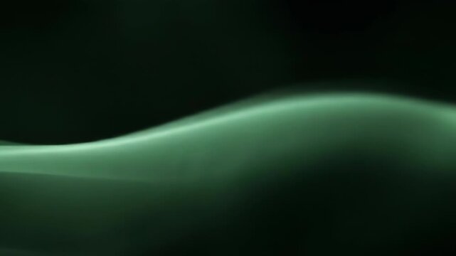 A green wave-like light streak on a black background with a white bottom section