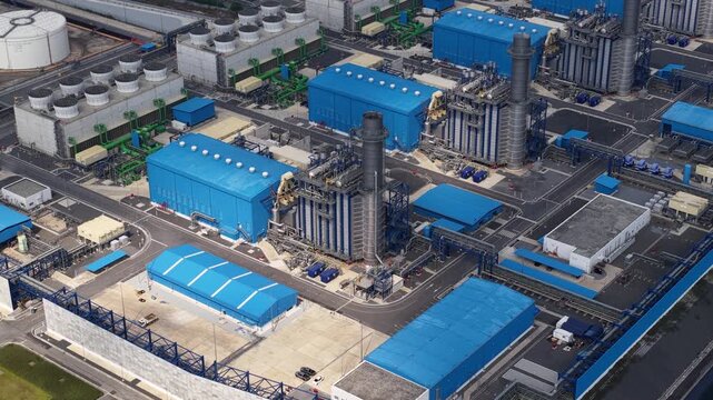 High angle perspective showing a modern combined cycle gas turbine power plant, detailing its infrastructure, cooling towers, and turbines, highlighting energy production and industrial technology