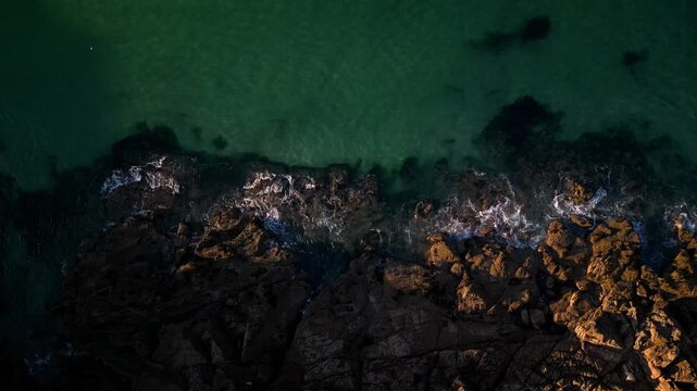 scenic aerial drone top view of cliffs and sea. Waves crashing against beautiful rocks, France Bretagne coat
