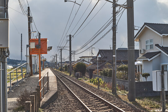 Quiet local station, rail tracks and suburban streets in a small Japanese town