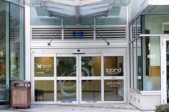 Blusson Spinal Cord Centre entrance at 818 with ICORD, Praxis, and Vancouver Coastal Health logos on glass sliding doors