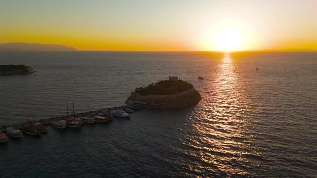 Kusadasi, Turkey. Historic Pigeon Island Fortress, once the base of Admiral Barbarossa, at sunset. Captures the iconic Pirate Castle. Aerial View