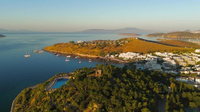 Bodrum, Turkey. Distant aerial drone view of Tiger Tower within restricted military zone. Ancient watchtower on wooded hilltop, visible from town but inaccessible to public.. Aerial View, MasterShots