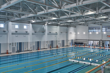 Fototapeta premium Olympic style indoor pool with lane dividers in spacious natatorium